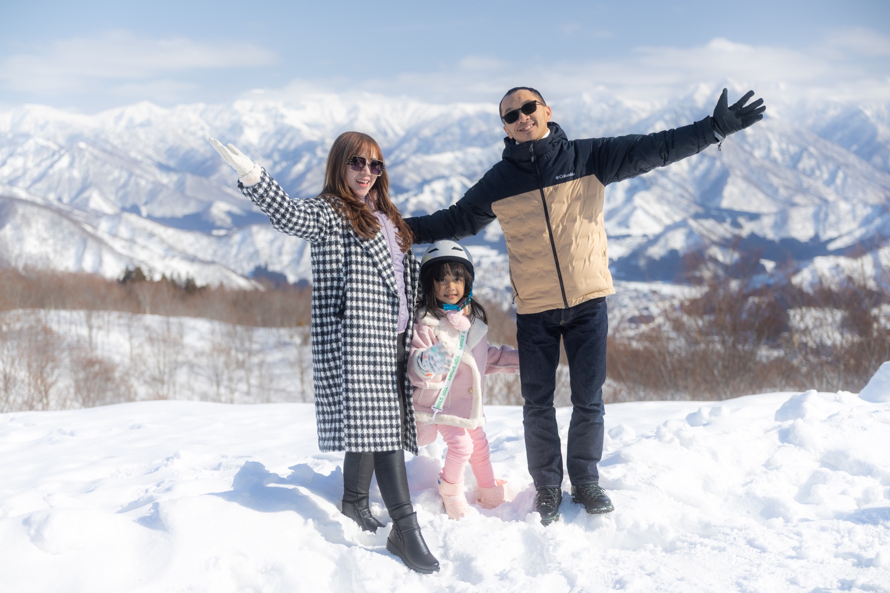 Family in snowy mountain scenery